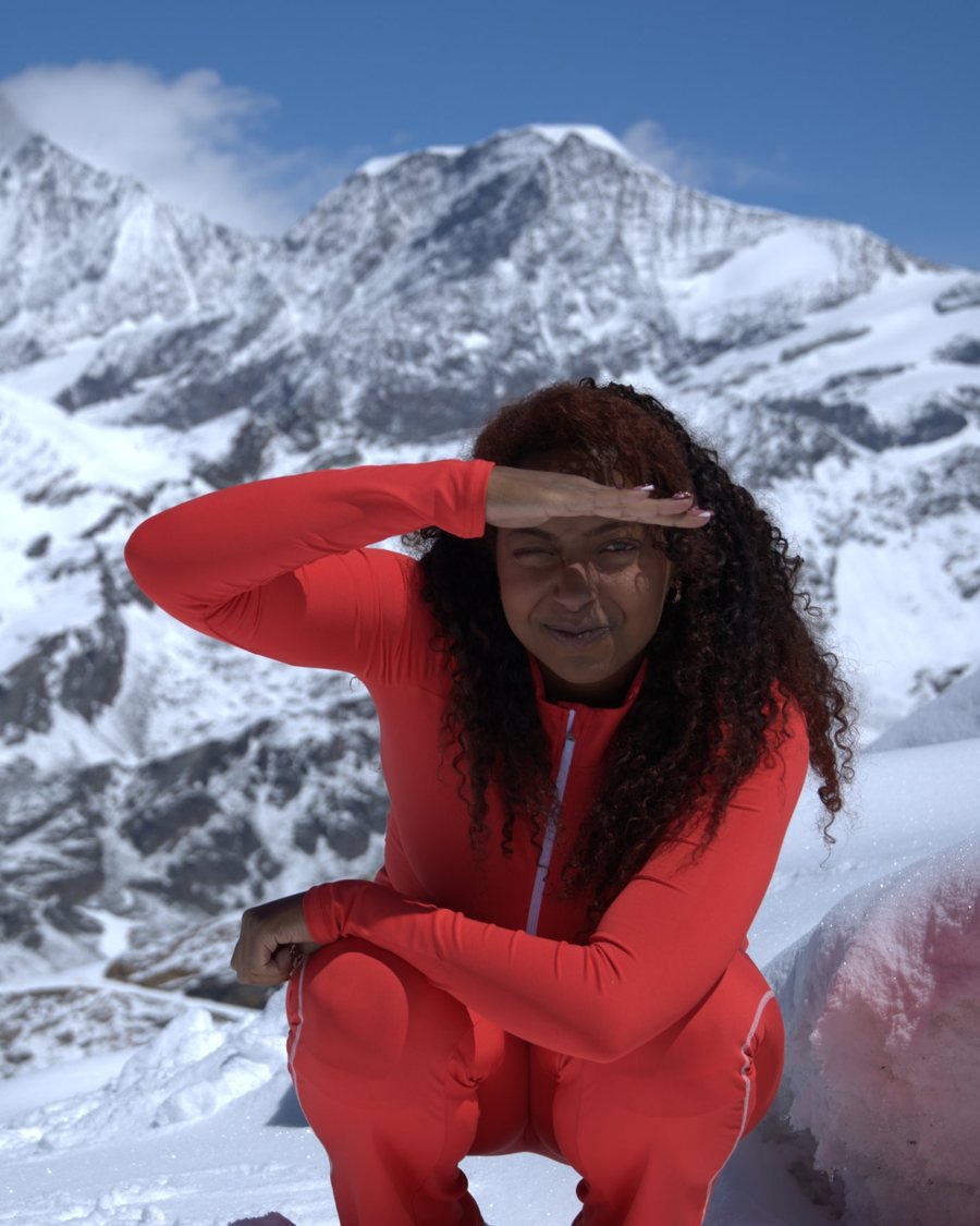 Nije, founder of Lumen Bloom Studios, on a snowy mountaintop in Europe